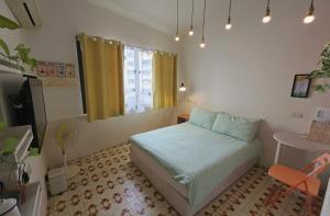 a small bedroom with a bed and a window at Avery case in Tainan +13 photos