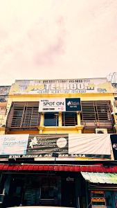 a building with a sign on the side of it at Bidara Guest House in Kampong Sungai Baru Tengah
