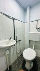 a bathroom with a toilet and a sink at Bidara Guest House in Kampong Sungai Baru Tengah +16 photos