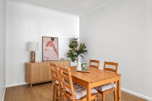 a dining room with a wooden table and chairs at Coolum Beach Apartment, 2 Bed 2 Bath, Pool in Coolum Beach