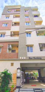 a large building with a sign in front of it at 1 BHK by Agartha Atithya in Hyderabad