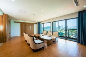 a conference room with chairs and a table and windows at The Golden Crest Hotel Quy Nhon in Quy Nhon