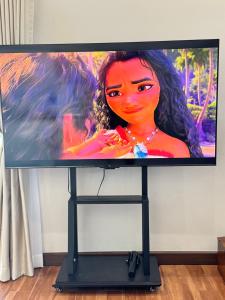a flat screen tv with a picture of a woman at Naruemon in Ban Madua Wan