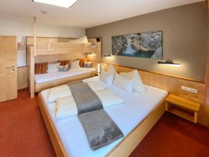 a bedroom with two beds and a bunk bed at Chesa Arella in Serfaus