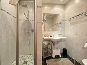 a bathroom with a shower and a sink at Chesa Arella in Serfaus +38 photos