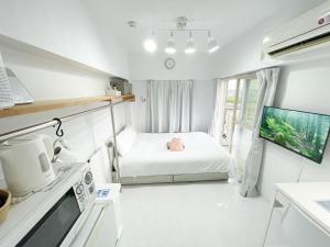a small room with a bed and a kitchen at Kameari 911 - 9F Newly Renovated Corner Room High Floor Near Station Mall Disney Access in Tokyo +19 photos