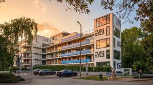 a rendering of a building with cars parked in a parking lot at Aranyhíd Apartman in Balatonföldvár