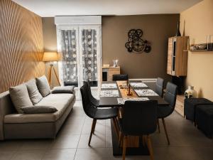 a living room with a table and a couch at LE TOURISTIC Appartements T2 et T3 in Luz-Saint-Sauveur