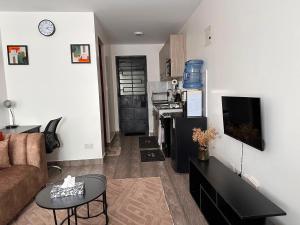 a living room with a couch and a table at Homes by Sil Bn in Muchatha +4 photos