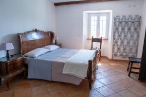 a bedroom with a bed and a table and a window at Residenza Villa Paradiso in Villadossola