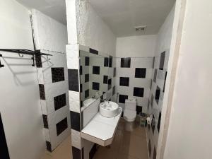 a white bathroom with a sink and a toilet at Kwarto's in Siquijor +99 photos