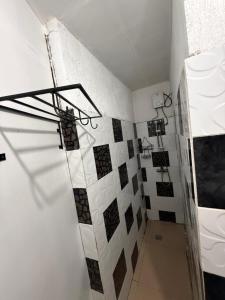 a bathroom with a shower with a toilet and tiles at Kwarto's in Siquijor