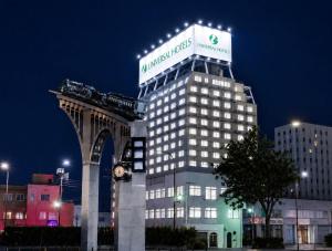 a building with a sign on the top of it at Yonago Universal Hotel in Yonago