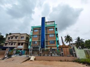 a building with a blue column on it at ICONIC Hotel Digha in Digha
