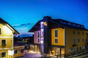 a building with a sign on the side of it at Hotel Gasthof Kamml in Wals