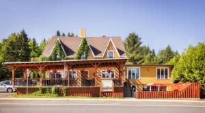 une maison avec un kiosque sur le côté de la rue dans l'établissement Auberge Au Soleil Levant, à Piopolis