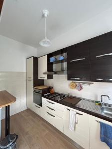 a kitchen with white cabinets and black appliances at Villa Nina in Caporciano