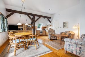 a kitchen and living room with a wooden table and chairs at Deelenwohnung in Trebel