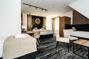 a hotel room with two beds and a couch at Malinowy Potok in Białka Tatrzańska +88 photos