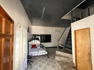 a room with a staircase with a bed in it at Kwarto's in Siquijor