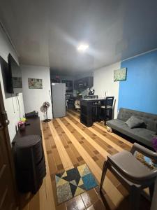 a living room with a couch and a table at Lugar de paz cerca de Upala in Upala