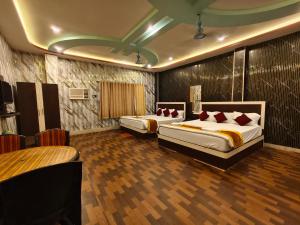 a hotel room with two beds and a bar at ICONIC Hotel Digha in Digha