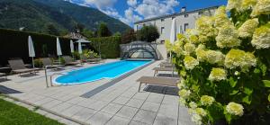 a villa with a swimming pool and a house at Pension Sattlerenglhof in Laces