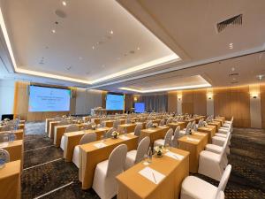 a conference room with tables and chairs and a projection screen at Jazzotel Bangkok in Bangkok +68 photos