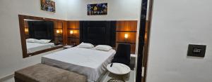 a small room with two beds and a mirror at The Eros in Sonīpat