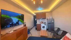 a living room with a large flat screen tv on the wall at 1403-304 Saekyung Pool view in Lapu Lapu City