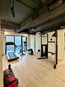 a gym with several exercise equipment in a room at Nova Concierge Aparthotel in Batumi