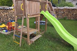 a wooden playset with a slide and a playground at NEU! Ferienwohnung am Schanzenbach in Hartha