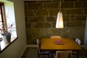 a dining room table with chairs and a light fixture at The Storekeeper's in Buckland