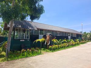an elephant statue standing in front of a building at Chill Hutz in Vedakudiyiruppu