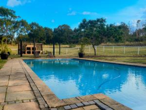 a swimming pool in the middle of a yard at The Meadow Manor in Port Edward