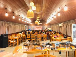 a dining room with people sitting at tables at Chill Hutz in Vedakudiyiruppu
