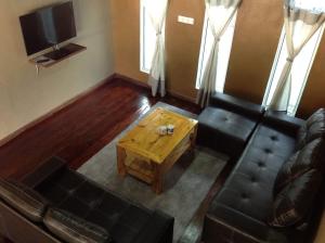 a living room with a couch and a coffee table at Villa Sri Tebengau in Kuah