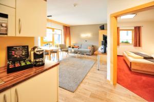 a room with a kitchen and a living room at Chesa Arella in Serfaus