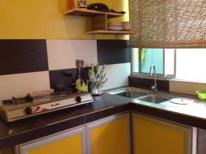 a kitchen with a sink and a counter top at Villa Sri Tebengau in Kuah