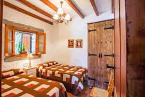 a bedroom with two beds and a sliding door at Casa Oronado in Ingenio +11 photos