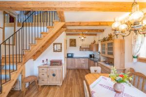 a kitchen and dining room with a staircase and a table at Haus Sunnseit'n in Pöllauberg
