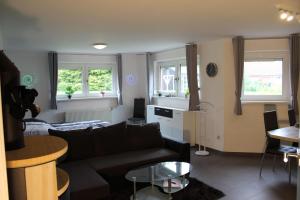 a living room with a couch and a table at Landluft in Gnissau