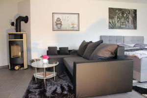 a living room with a couch and a bed at Landluft in Gnissau +14 photos