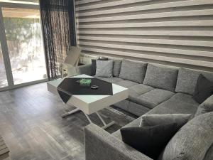 a living room with a couch and a coffee table at Lesnasr chalet apartments in Al ‘Aqabah +1 photo