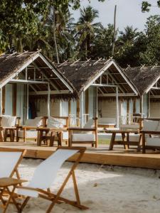 a group of tables and chairs in front of a resort at La Belle Hollow Trees in Katiet +40 photos