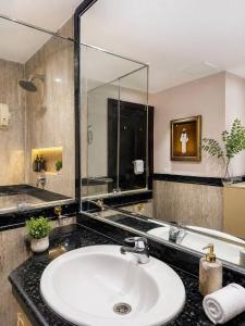 a bathroom with a sink and a large mirror at Egypt Aziz pyramids in Cairo