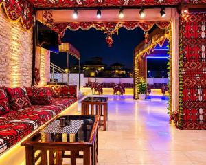 a living room with a couch and a table and lights at Egypt Aziz pyramids in Cairo