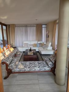 a living room with a couch and a table at Mosia Guest House in Maseru