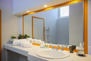 a bathroom with a sink and a large mirror at Villa Francesca in Capri