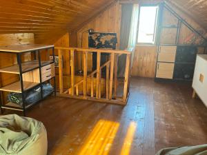 a room with wooden walls and a wooden floor at Orbis Bude in Samshvilde